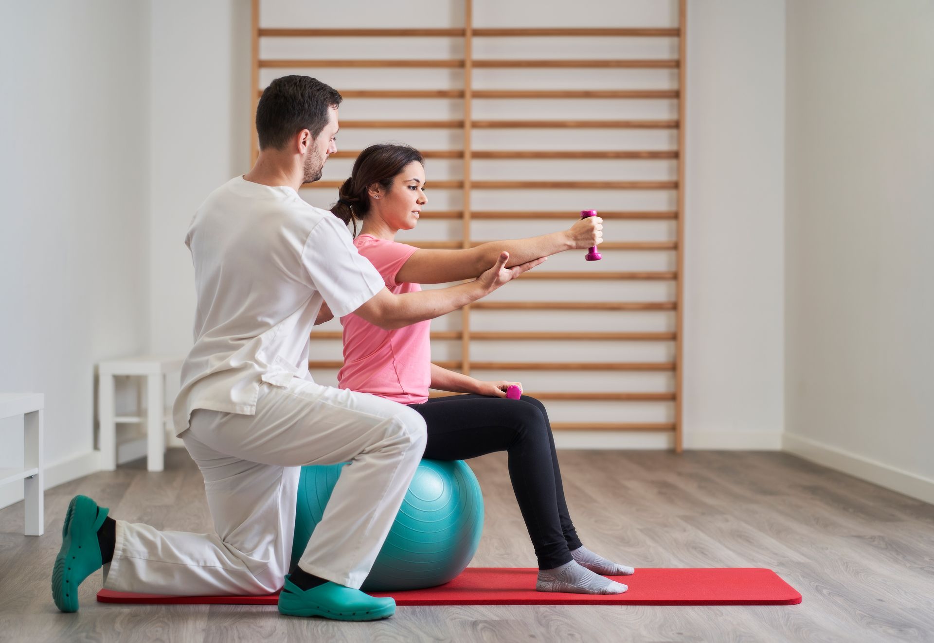 physiotherapist helping patient exercise