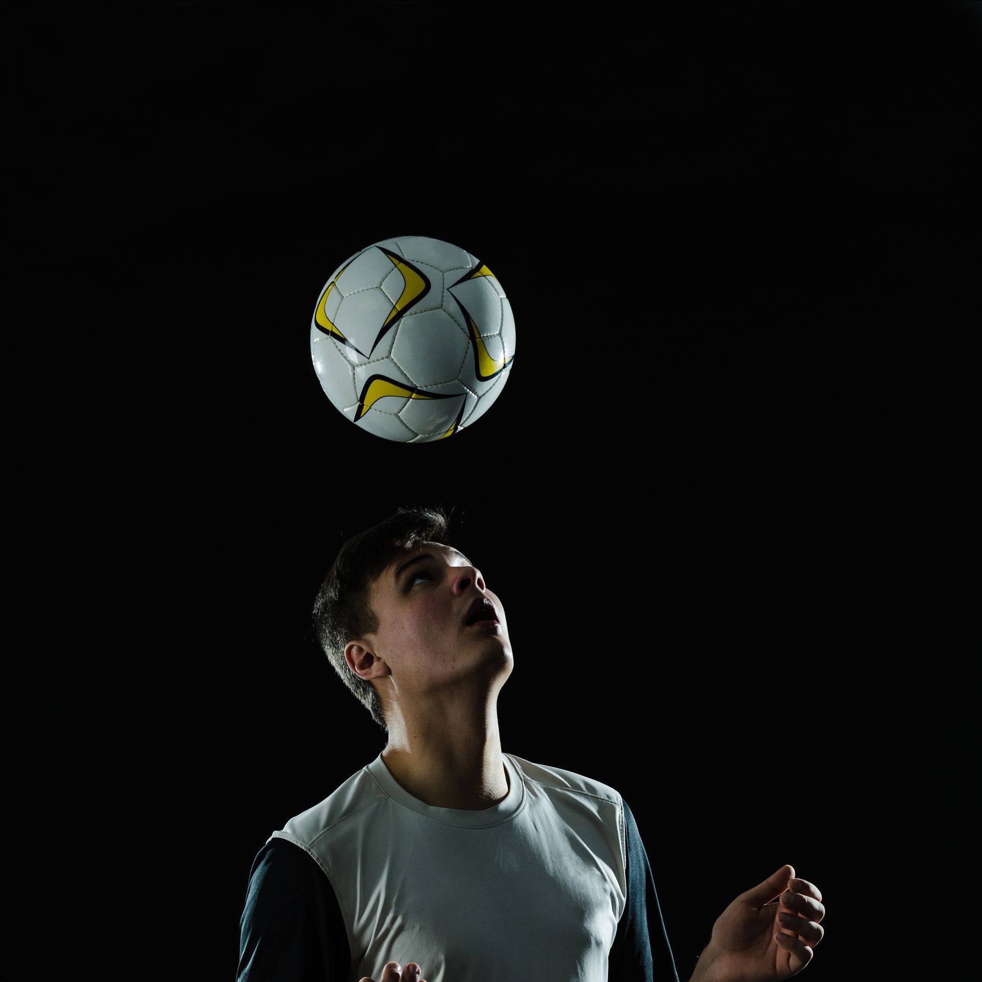 soccer player  juggling the ball with his head