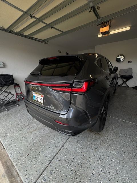 Dark gray SUV parked in a residential garage with the rear hatch open slightly