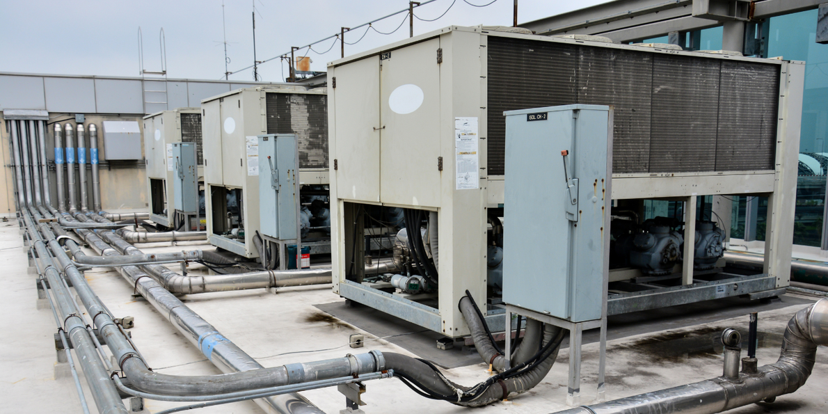 A row of air conditioning units on the roof of a building.