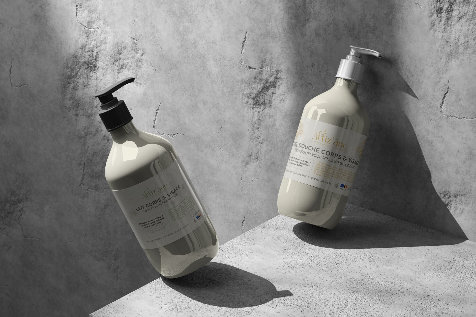 Deux flacons couleur crème, étiquetés et munis de pompes distributrices, appuyés contre une surface grise texturée.
