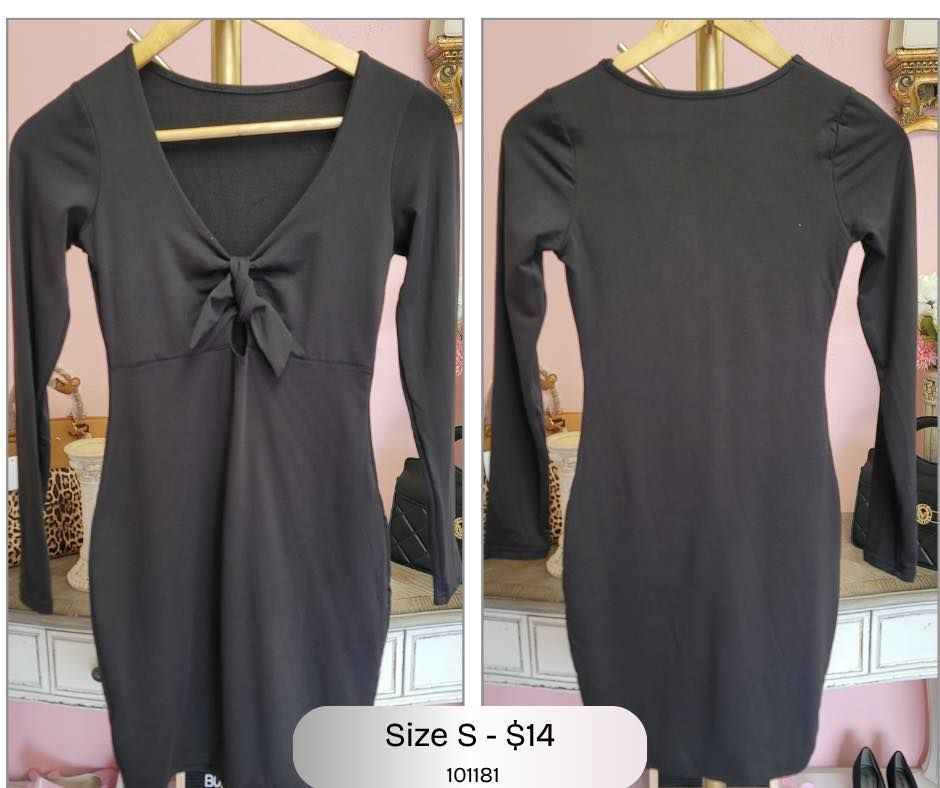 A black dress with long sleeves and a bow on the front