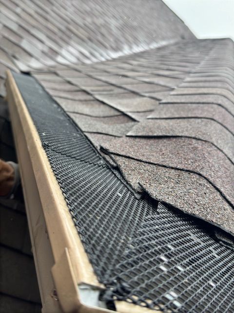 A close up of a gutter on the roof of a house.