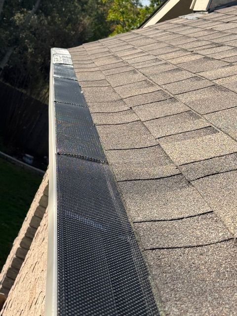 A close up of a gutter on the side of a roof.