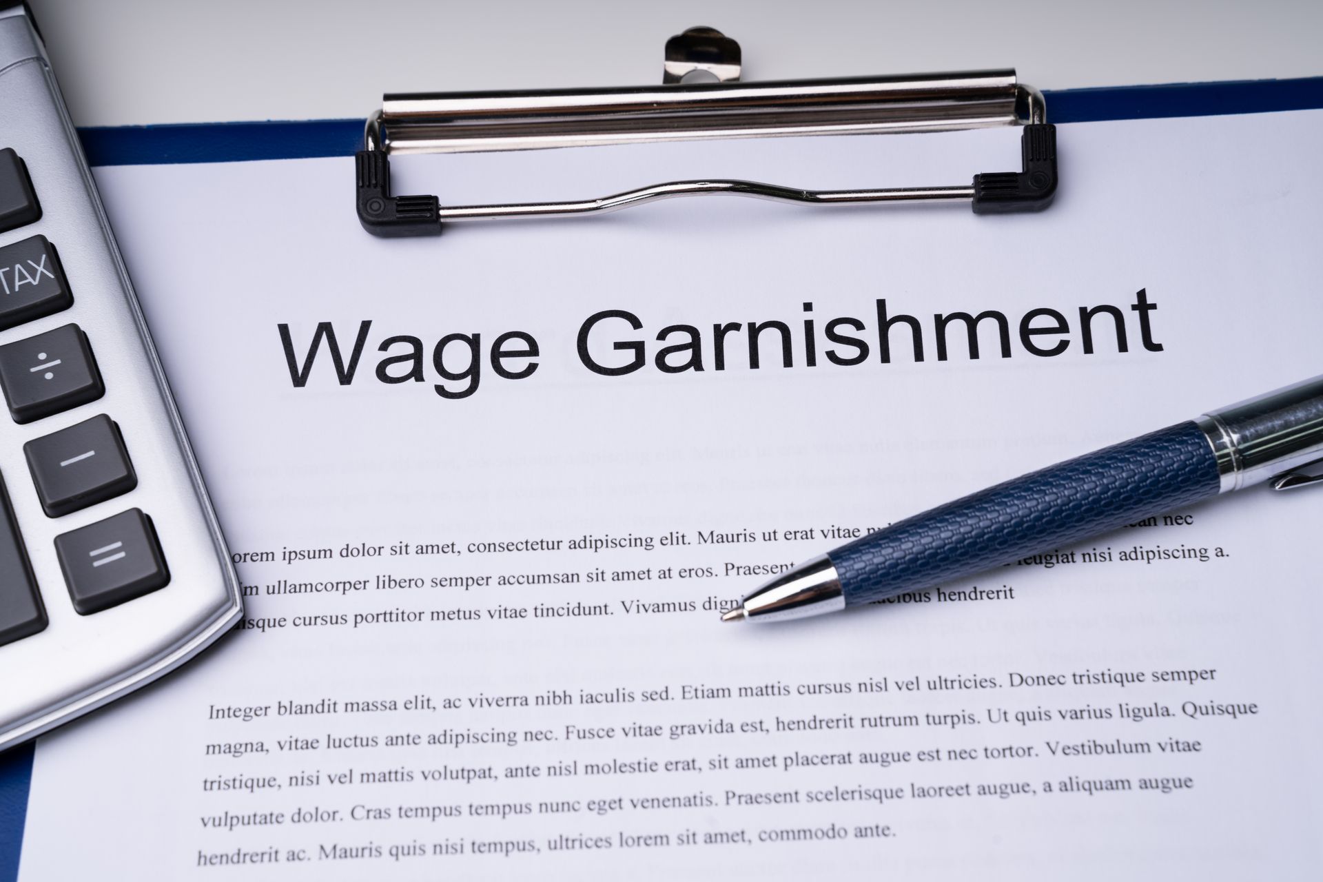 Wage Garnishment document with a calculator and pen on a clipboard.