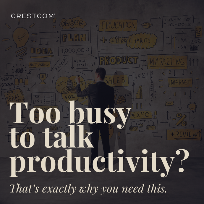 A man standing in front of a white board that says too busy to talk productivity