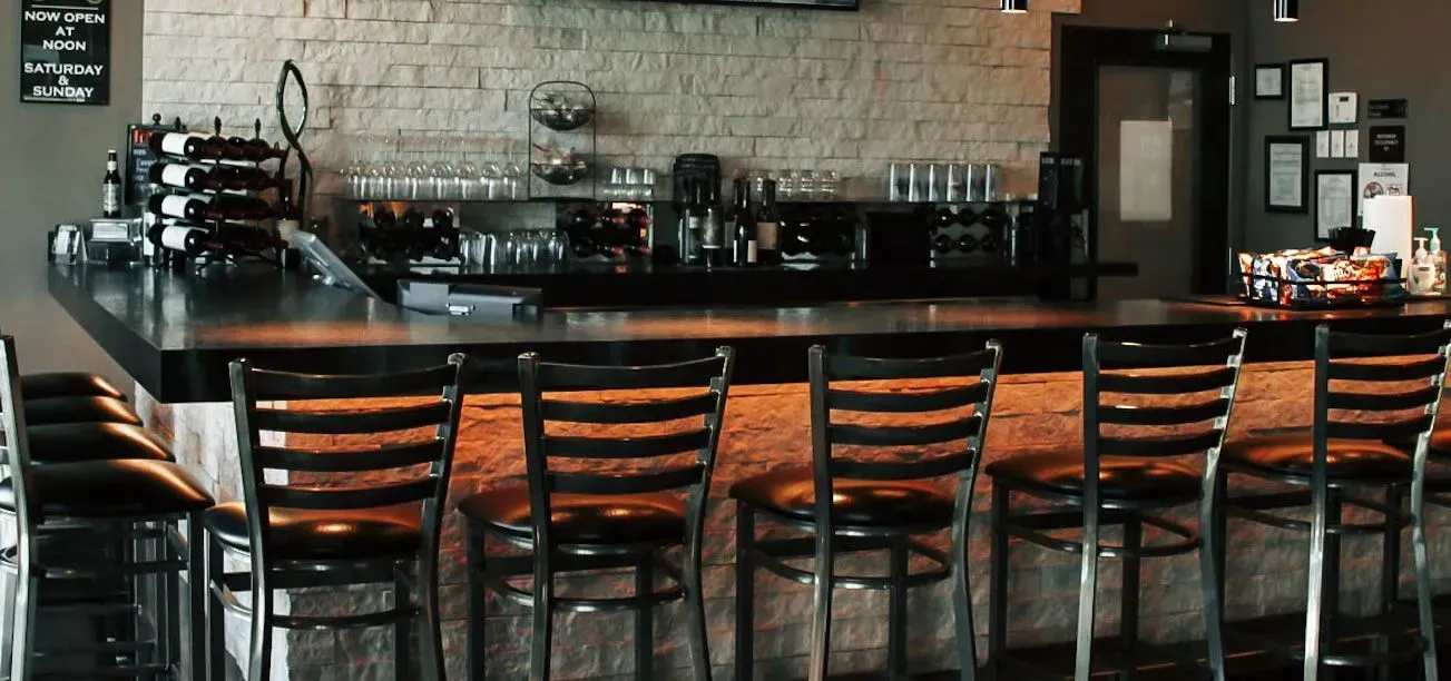 A restaurant with tables and chairs and flowers on them.