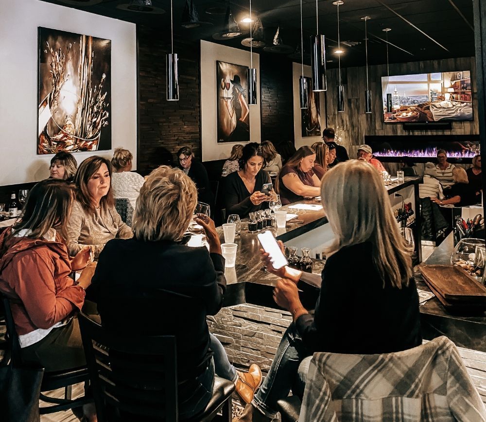 A group of people are sitting at tables in a restaurant.