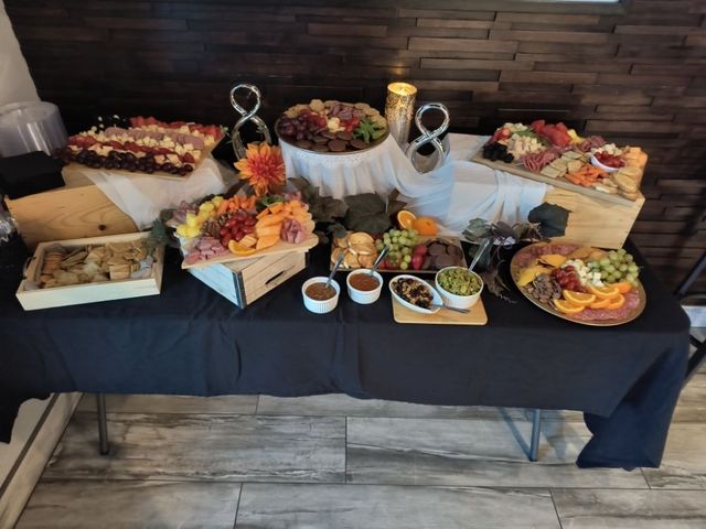 A table with a lot of food on it and a black table cloth.