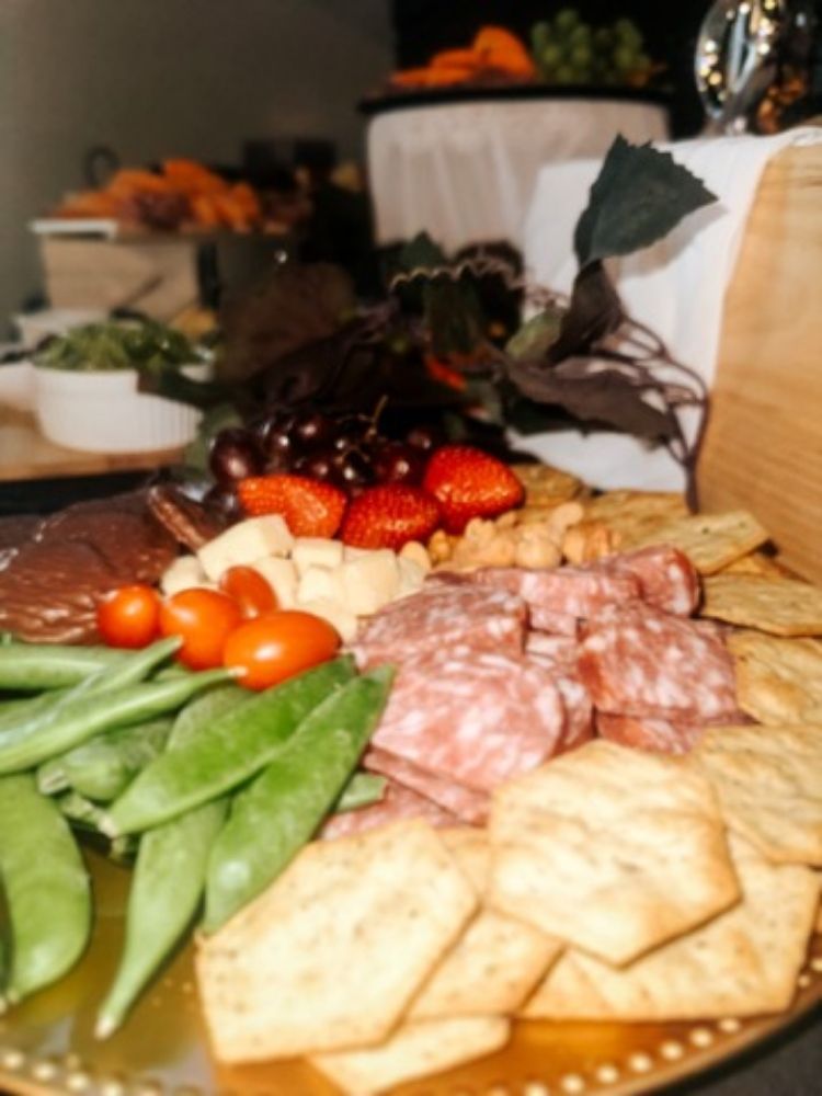 A plate of food with crackers and vegetables on it