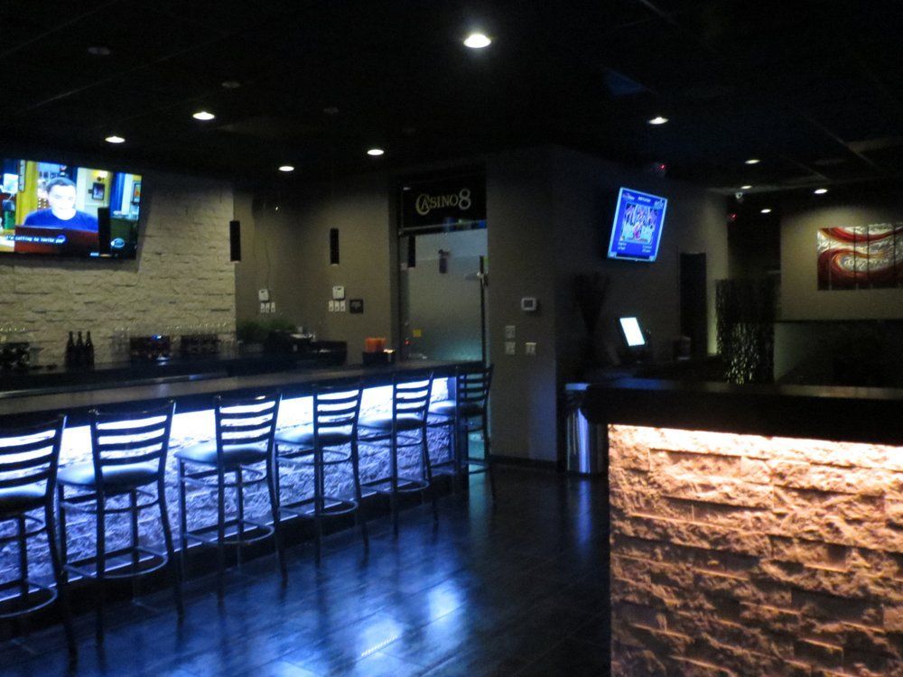A bar with stools and a sign that says ' coca cola ' on it