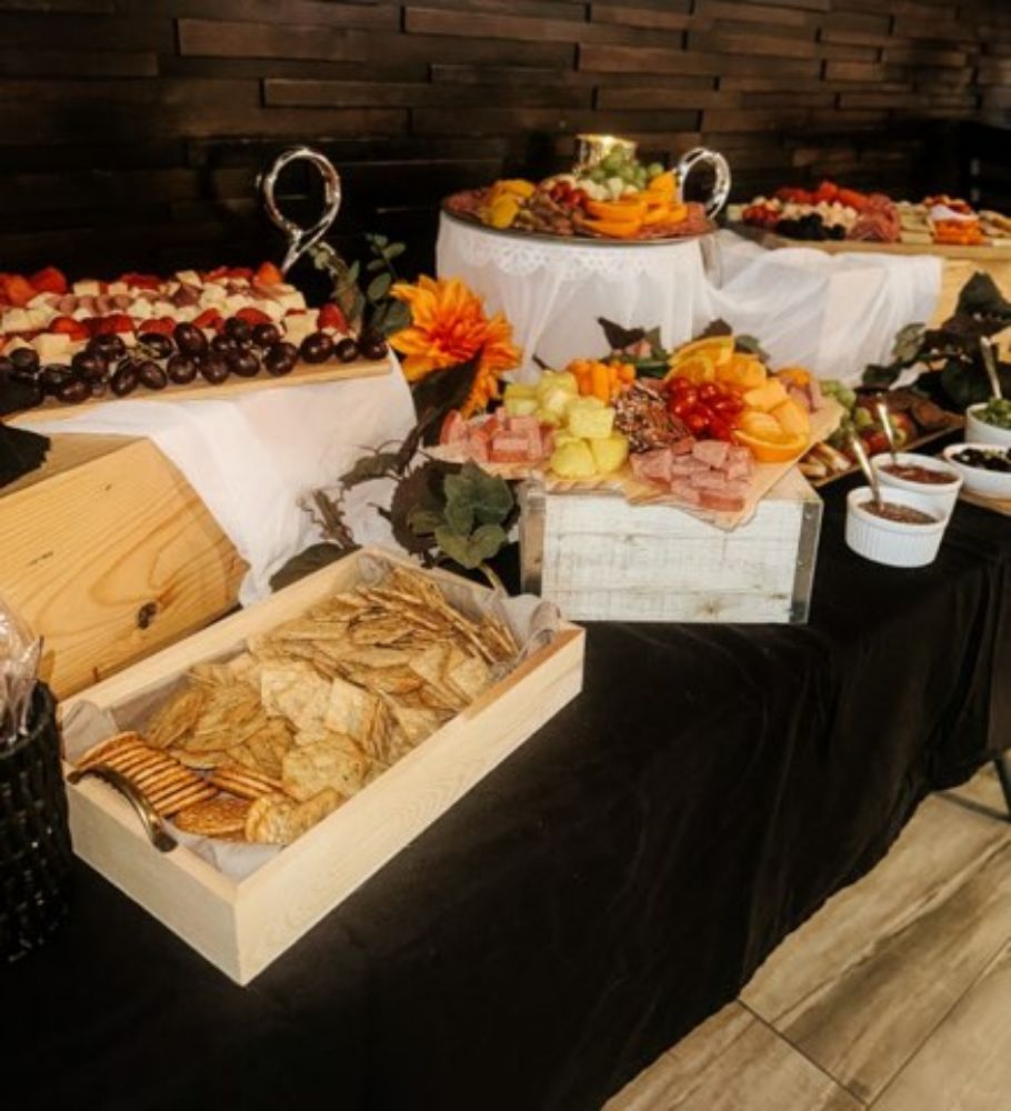 A buffet table with a wooden box of chips on it
