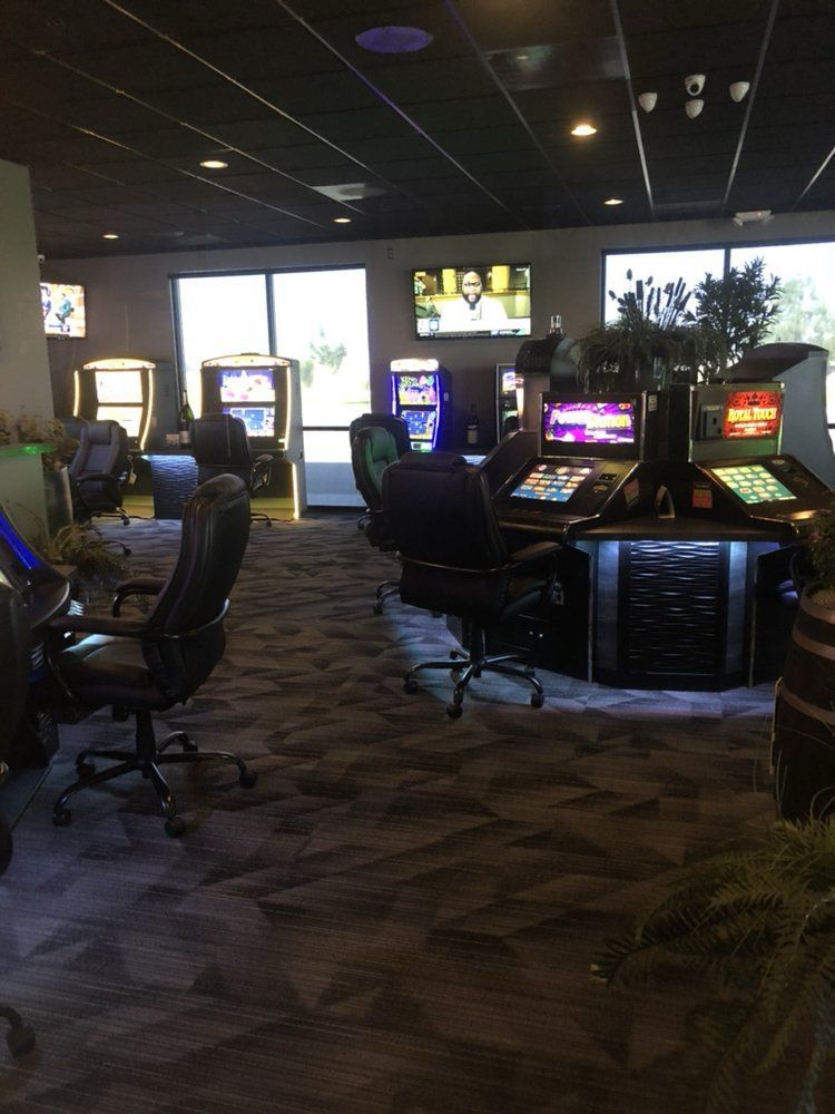 A room with a lot of arcade games and chairs