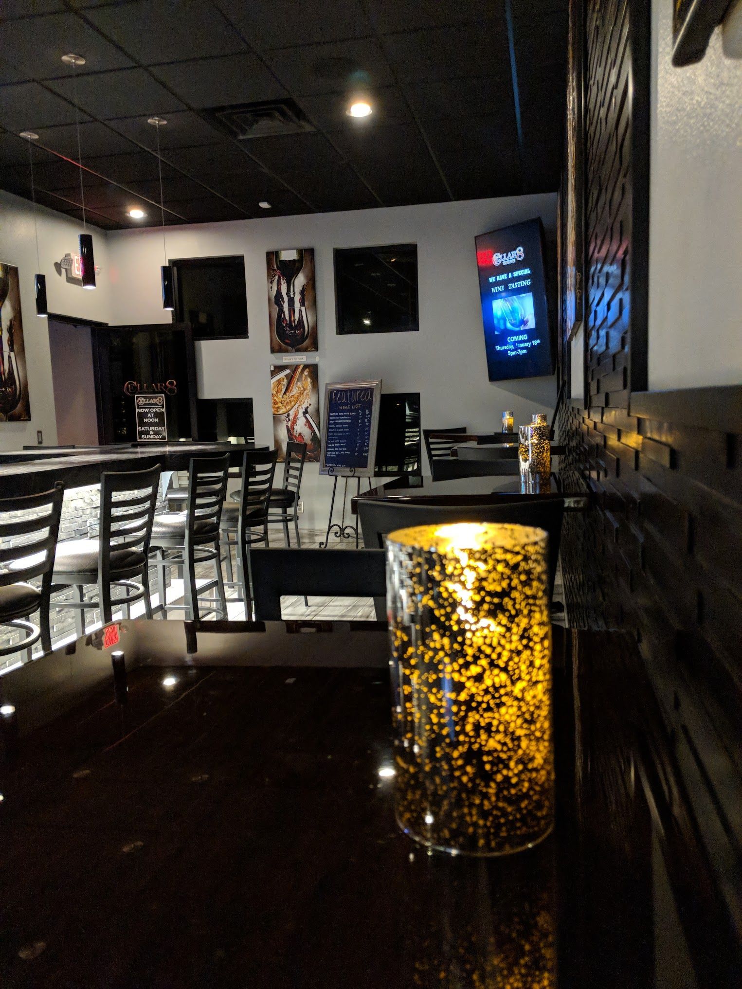 The inside of a restaurant with a candle on the counter