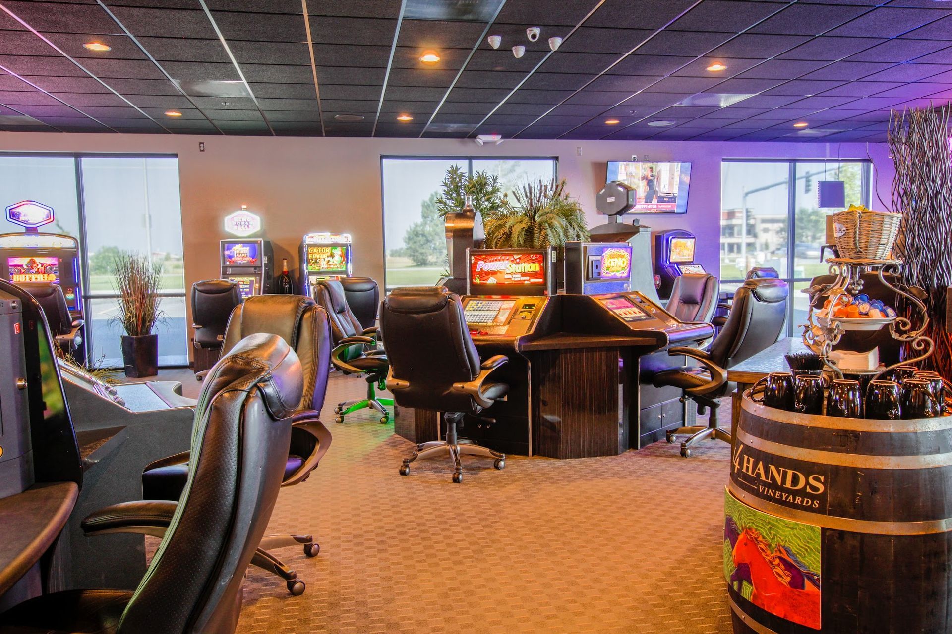 A large room filled with lots of chairs and tables with a barrel in the middle.