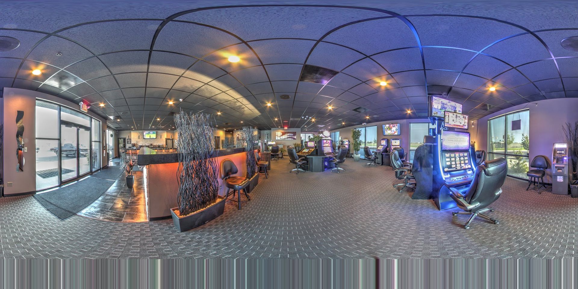 A panoramic view of a casino with a lot of tables and chairs.