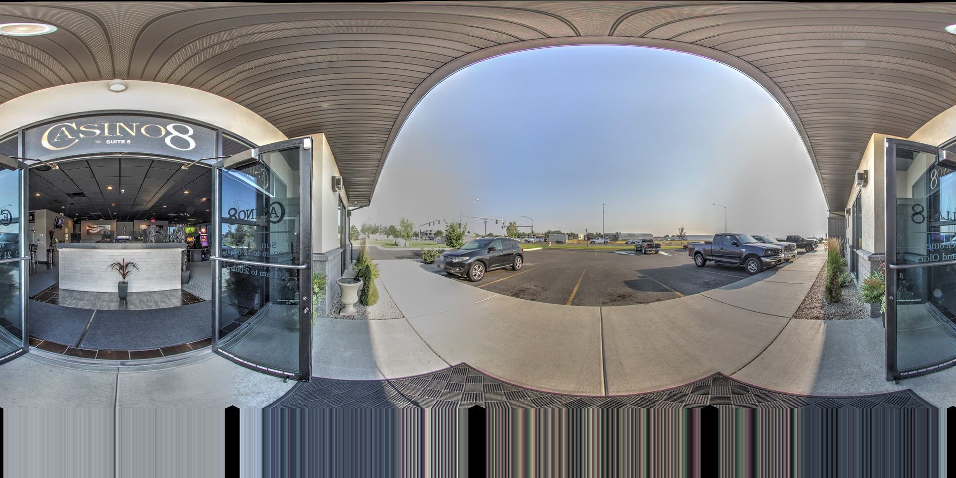 A 360 degree view of a building with cars parked in front of it.