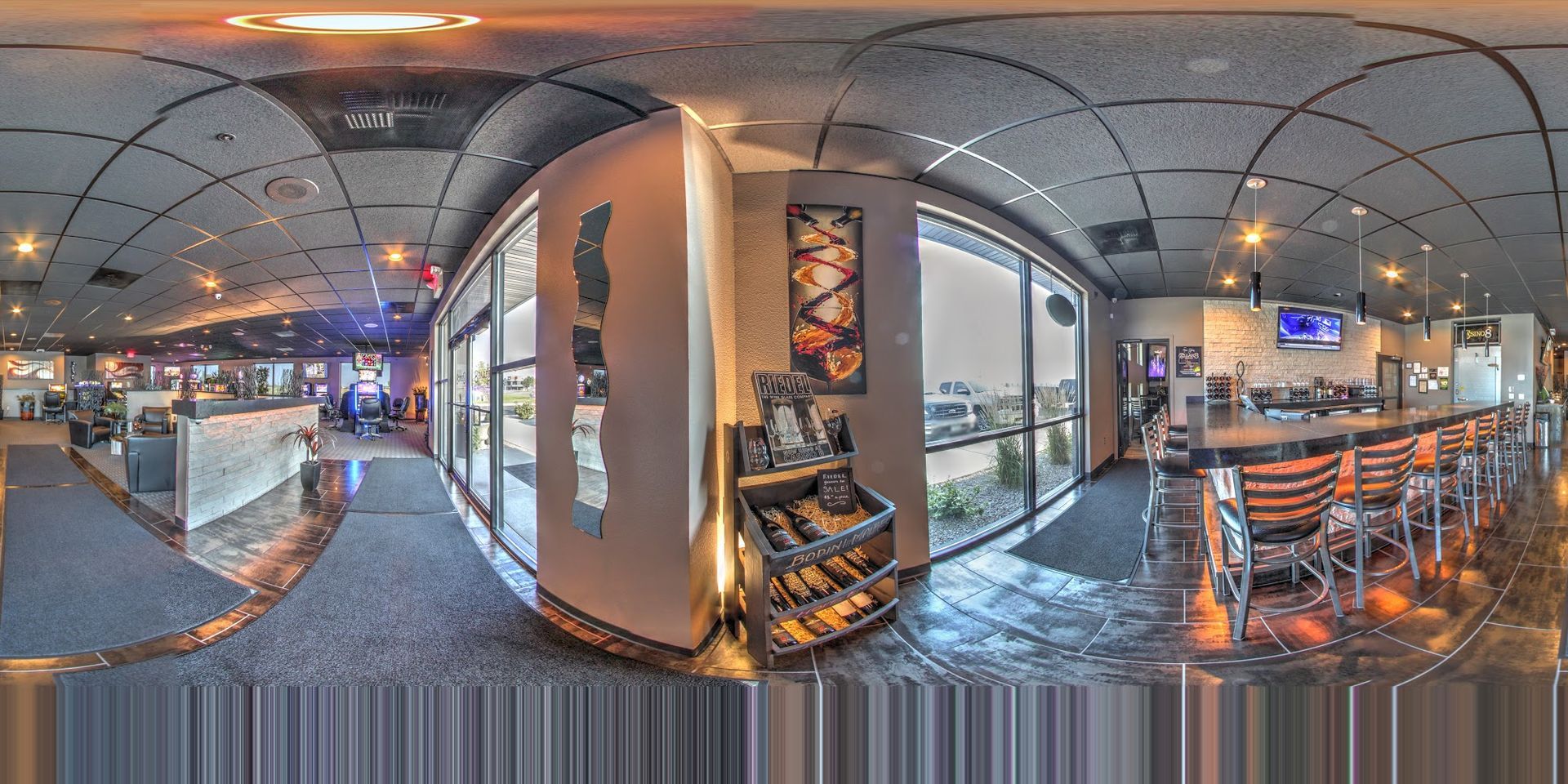 A panoramic view of a restaurant with a bar and tables.