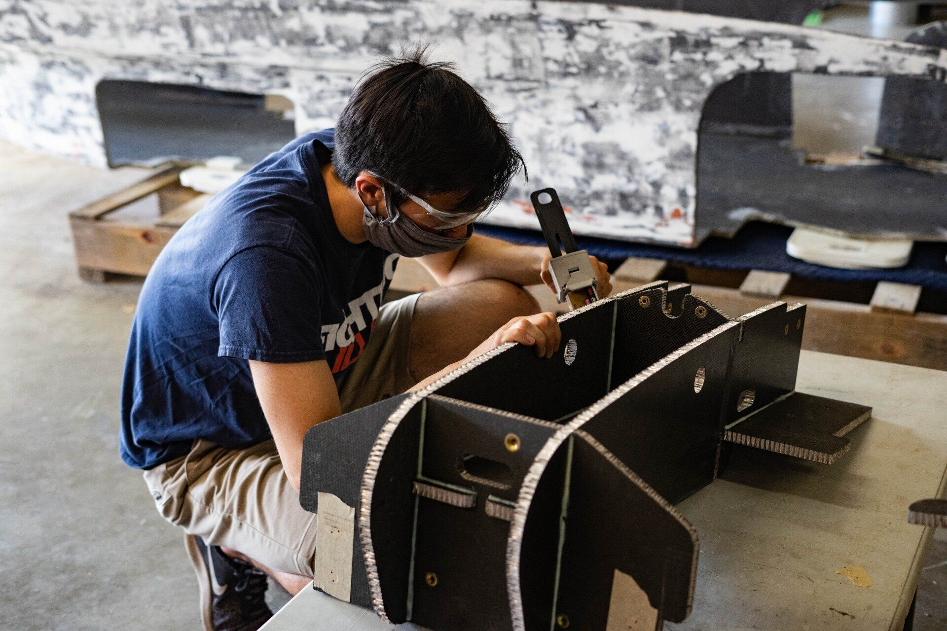 John applies epoxy to the chassis.