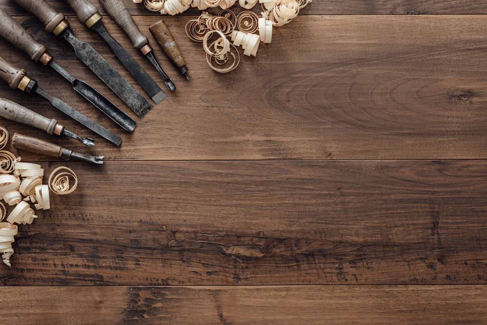 A Wooden Table Topped with Woodworking Tools and Wood Shavings — Radburn Carpentry in Tamworth, NSW