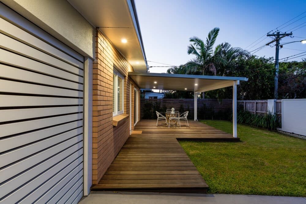 A House with A Wooden Deck and A Table and Chairs on It — Radburn Carpentry in Tamworth, NSW