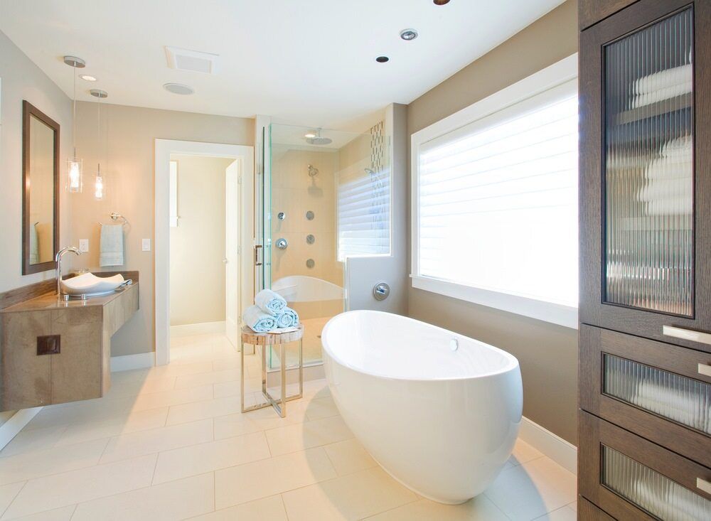 A Bathroom with A Tub , Sink , Mirror and Window — Radburn Carpentry in Tamworth, NSW