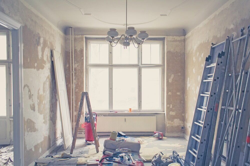 A Room that Is Being Remodeled with A Ladder and A Chandelier — Radburn Carpentry in Tamworth, NSW