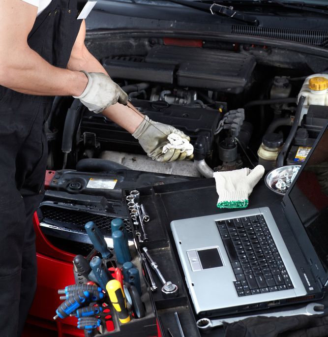Auto Mechanic Checking Oil — Mechanical Repairs in Bundaberg, QLD
