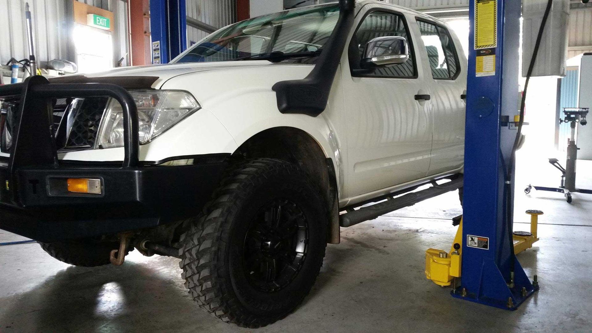 A White 4x4 Truck with Big Tyres — Mechanical Repairs in Bundaberg, QLD