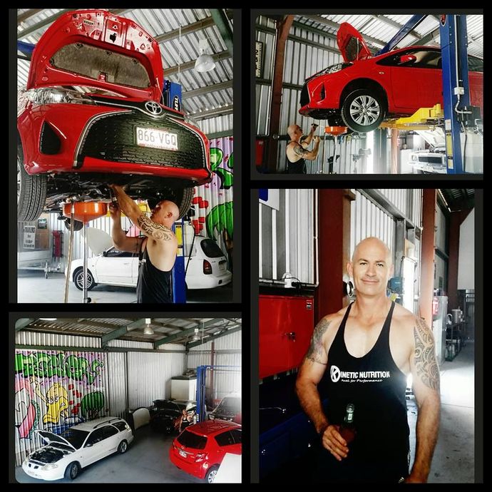 A Mechanic Fixing the Red Car — Mechanical Repairs in Bundaberg, QLD