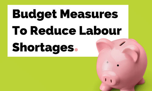 A pink piggy bank is sitting next to a sign that says budget measures to reduce labour shortages.