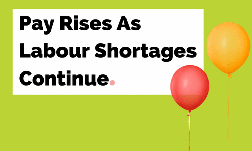 Two balloons are flying in front of a sign that says pay rises as labour shortages continue.