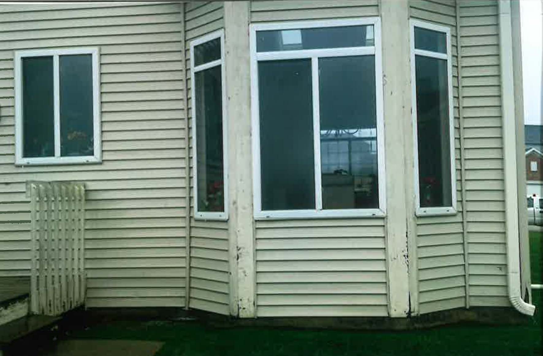 A white house with a large bay window