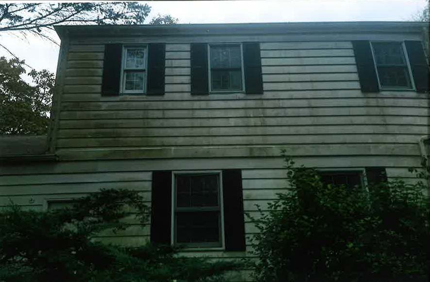A white house with black shutters on the windows