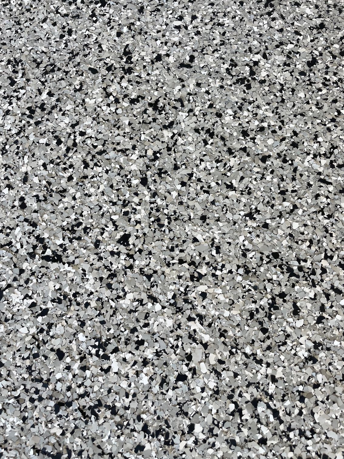 A close up of a gray and black marble floor.