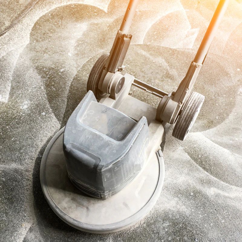 A lawn mower is sitting on top of a pile of sand.