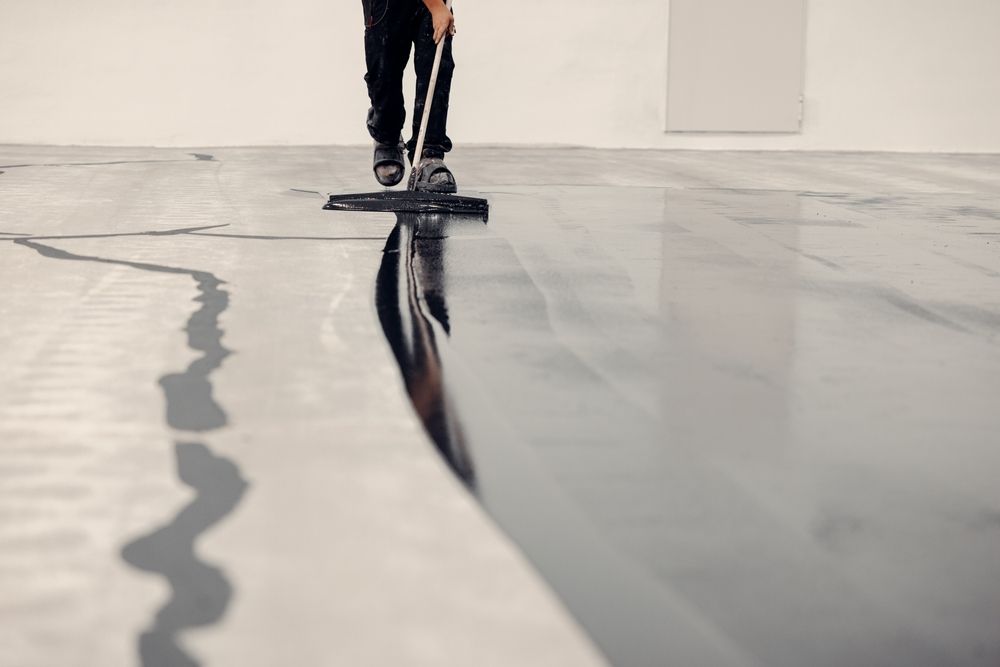 A person is sweeping the floor with a broom.