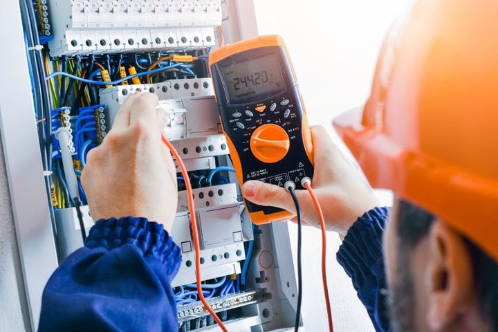 man checking commercial electrical  circuits