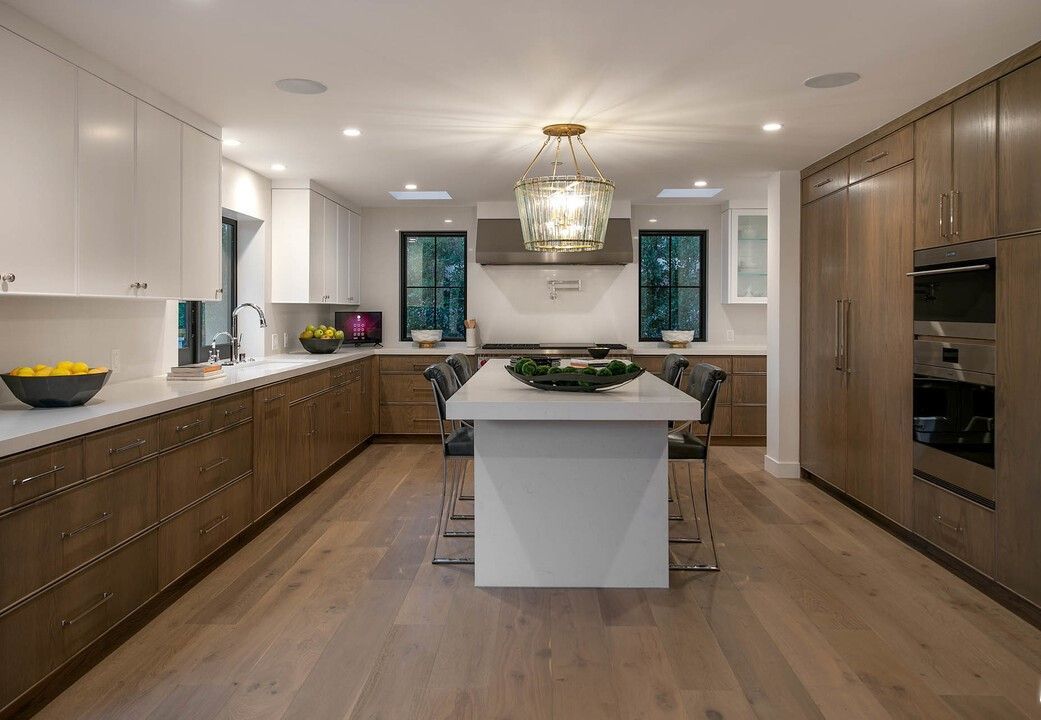 A kitchen with a large island in the middle