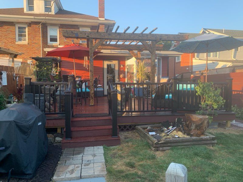 A White Vinyl Fence is Surrounded by Grass and a House