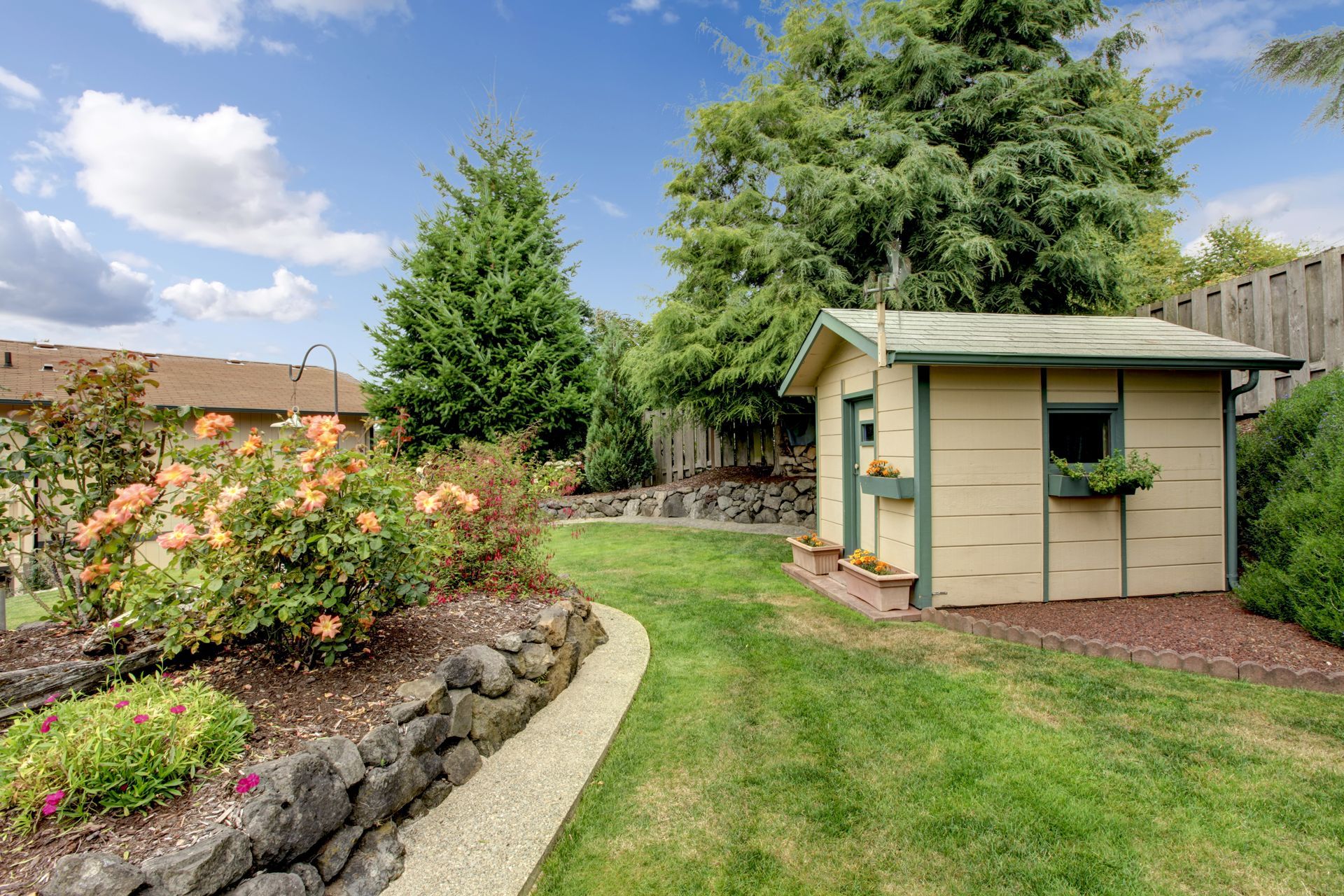 A Small Shed is Sitting in the Middle of a Lush Green Backyard