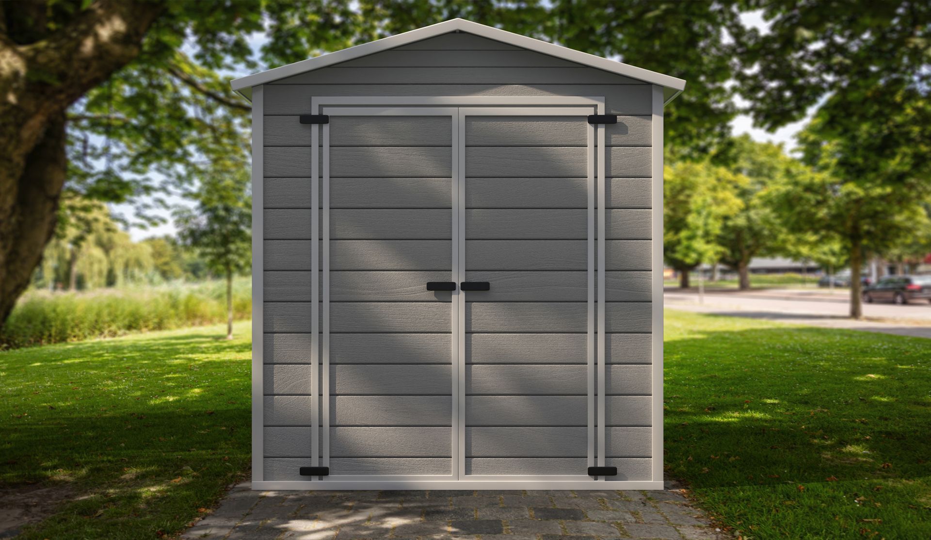 Gray storage shed with double doors in a grassy yard.