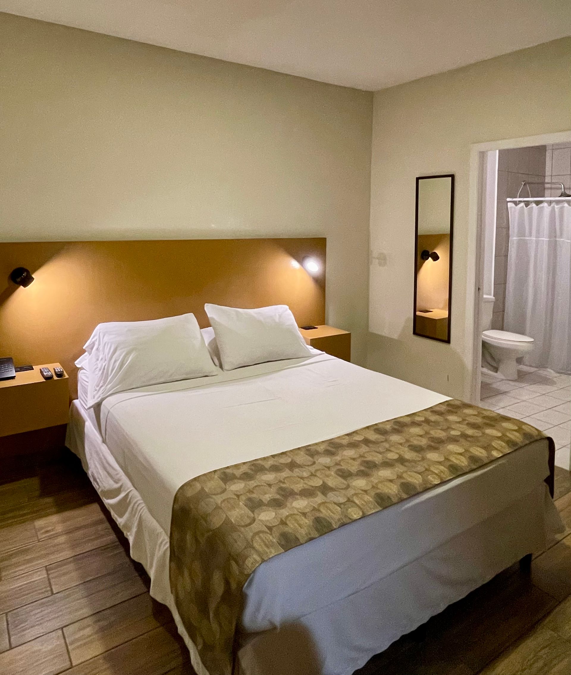 A hotel room with a bed and a bathroom