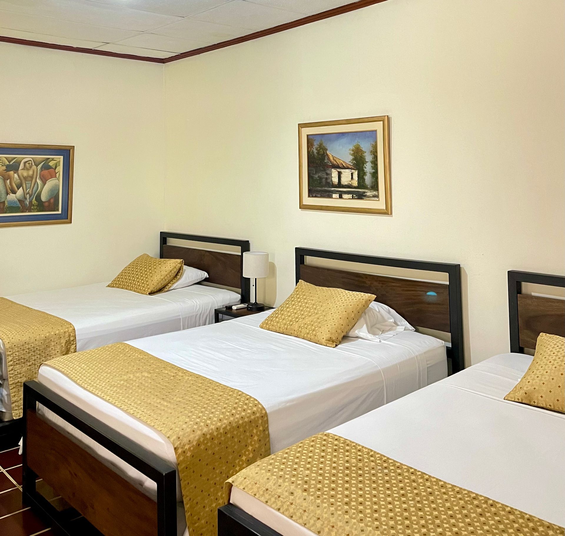 A bedroom with two beds and a picture on the wall