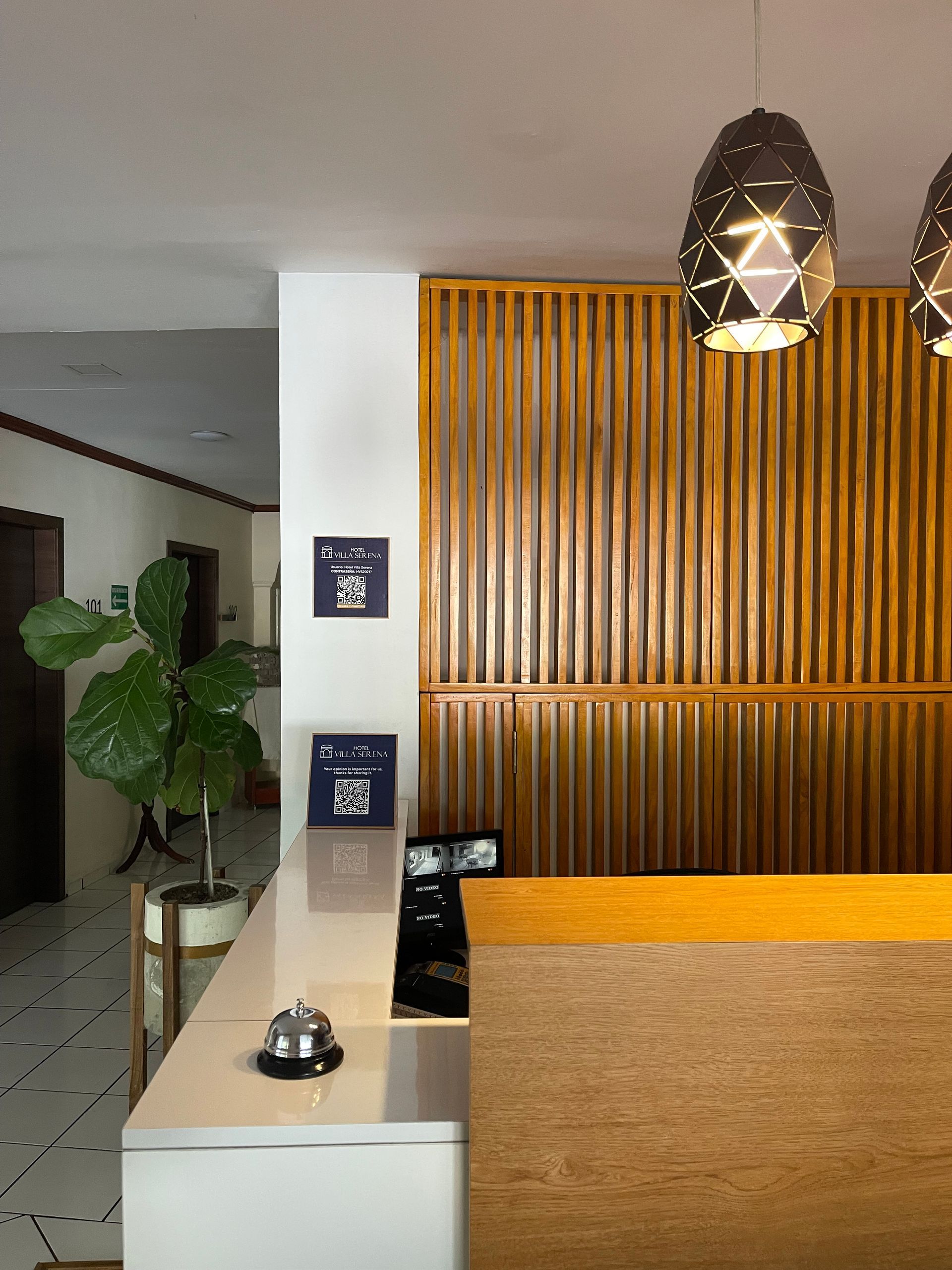 A hotel lobby with a wooden wall and a wooden counter