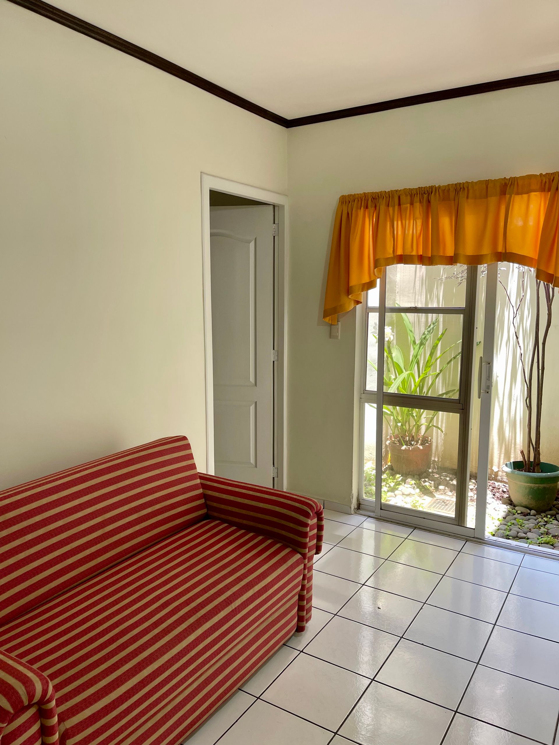 A living room with a red and white striped couch