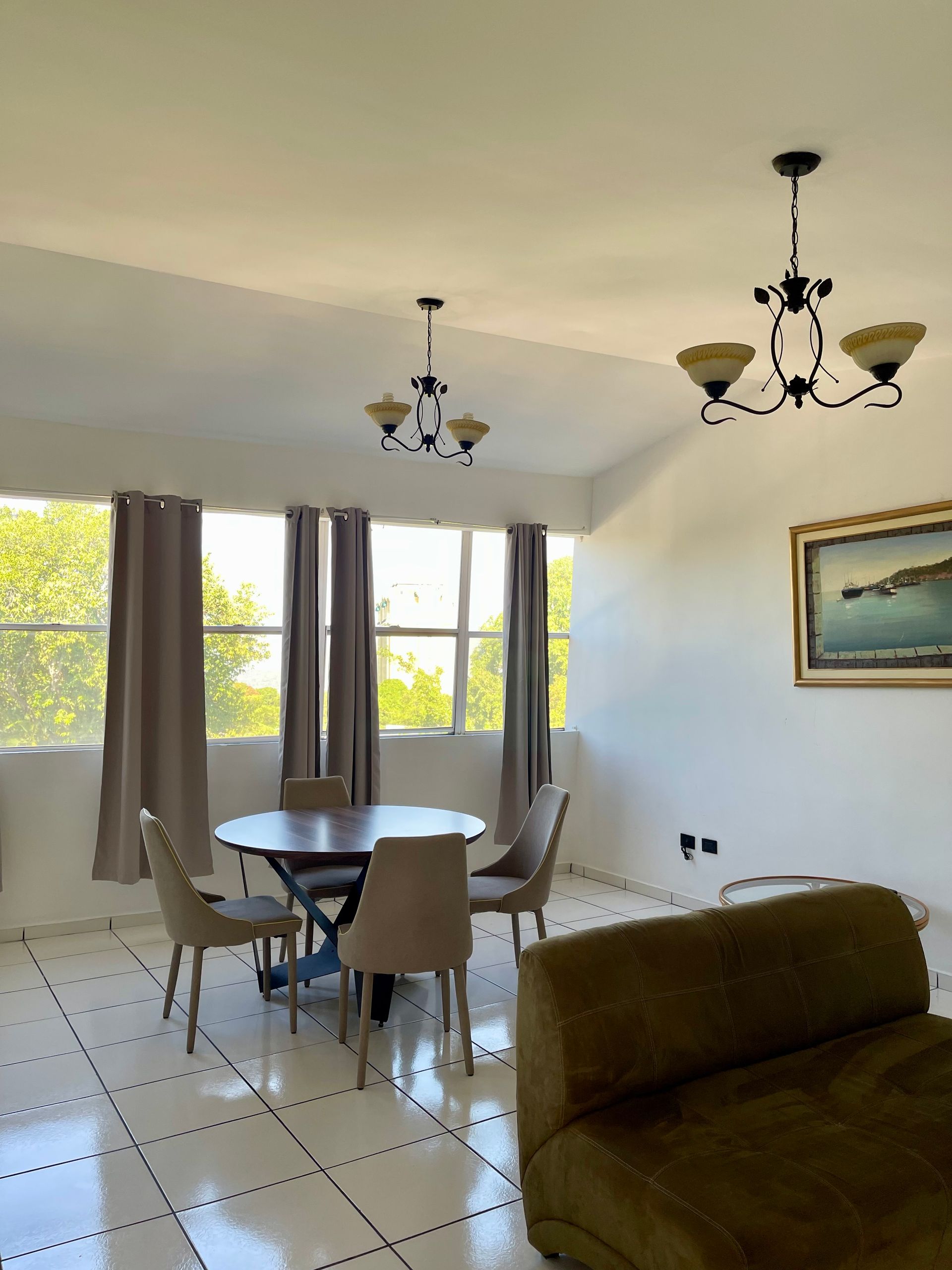 A living room with a round table and chairs