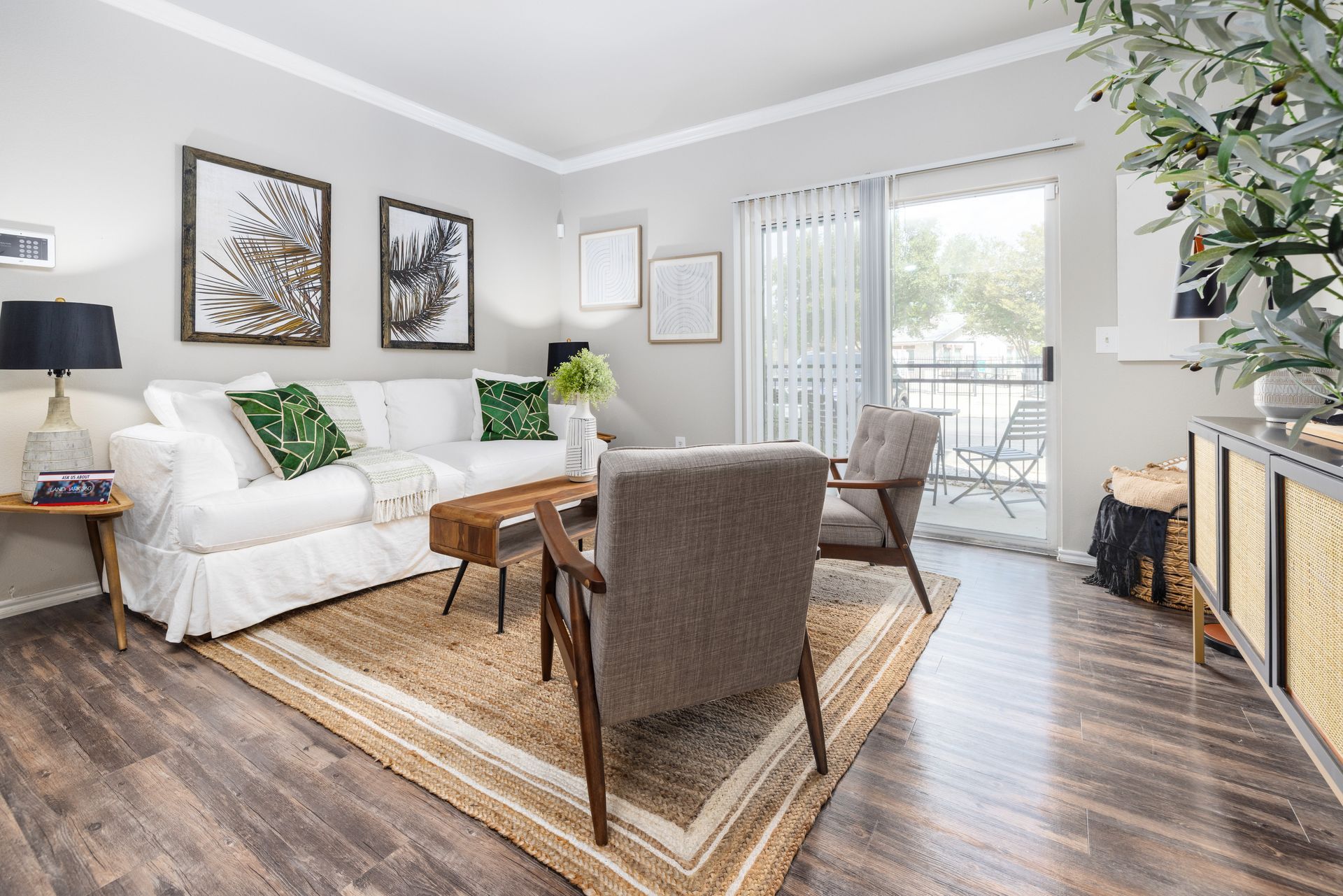 A living room with a couch , chair , table and rug.
