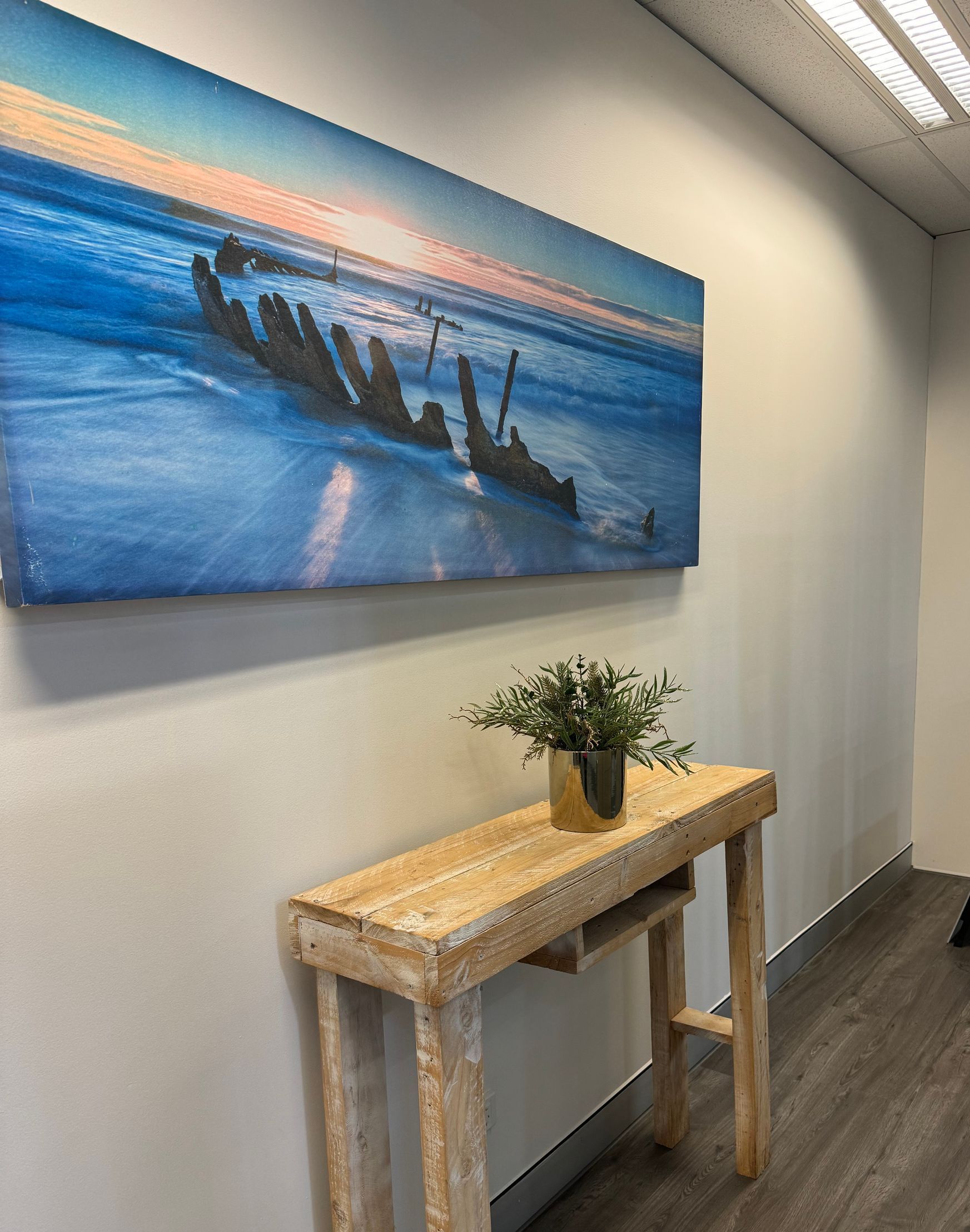 A Hallway With A Wooden Table And A Painting On The Wall — The Therapists Cairns In Cairns City, QLD