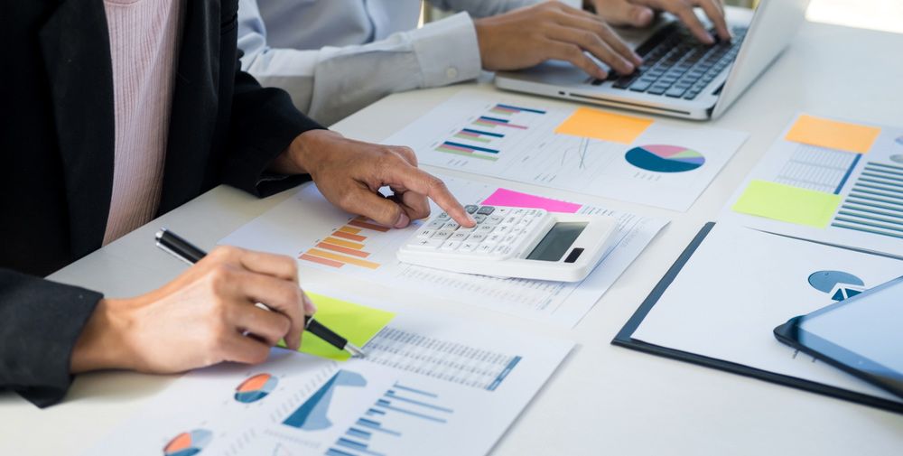 Two Accountant Calculating Balance — Dynamic Accounting Taxation Advisors in Lisarow, NSW